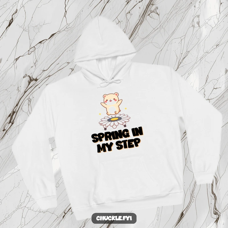Funny hoodie featuring a small, round animal character performing a joyful bounce on a daisy trampoline, radiating happiness and fun.