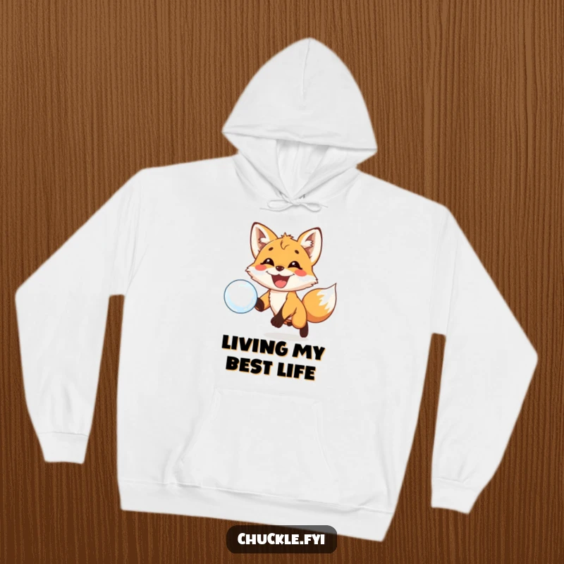 Funny hoodie showcasing a playful fox cub with a huge grin excitedly chasing a floating bubble. Warmth meets whimsy.