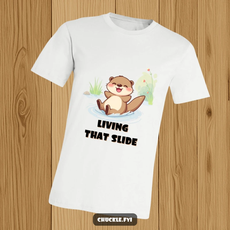 Funny T-Shirt: A happy otter character joyfully slides down a riverbank, showcasing pure, unadulterated fun.