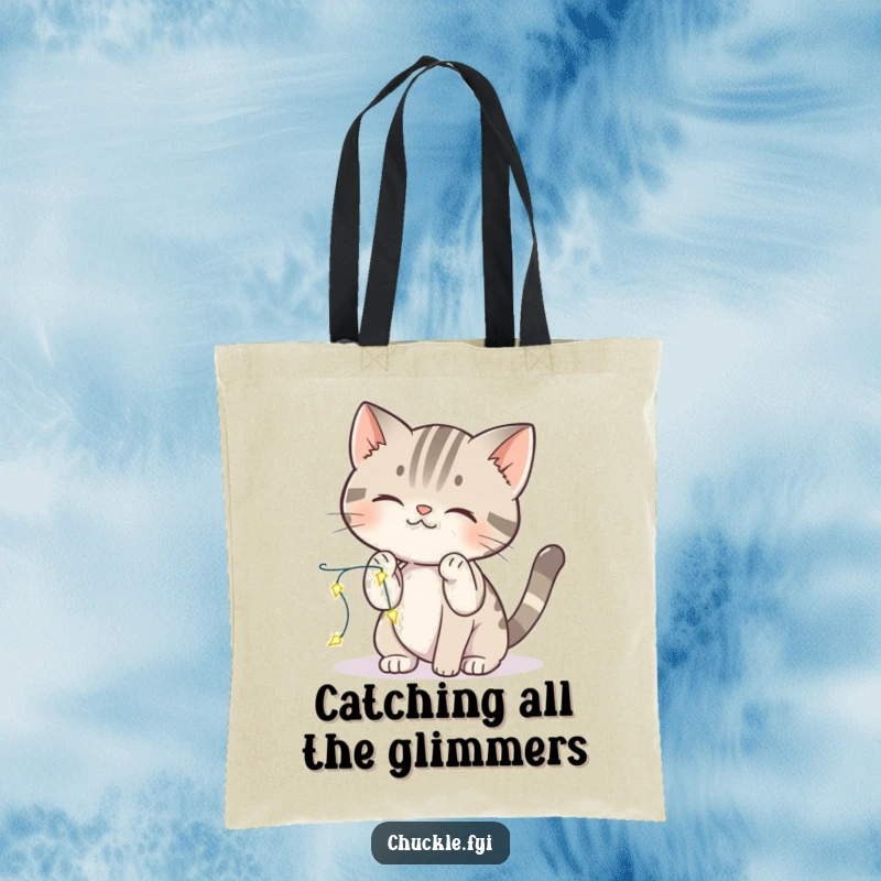 Funny cat tote bag showing a curious cat playfully batting at sparkling lights, a charming accessory.